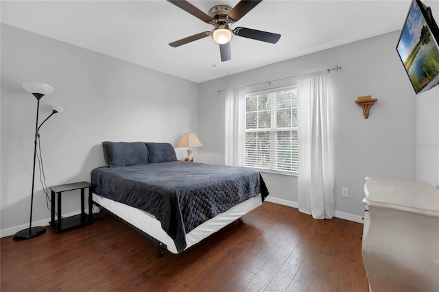 bedroom featuring baseboards, ceiling fan, and wood finished floors