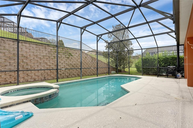 view of swimming pool with a patio, a pool with connected hot tub, central AC unit, and glass enclosure