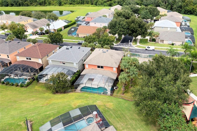 drone / aerial view featuring a water view and a residential view