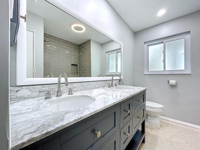 6268 39th Ave N, Saint Petersburg, FL 33709 - bathroom featuring a sink, baseboards, toilet, and double vanity