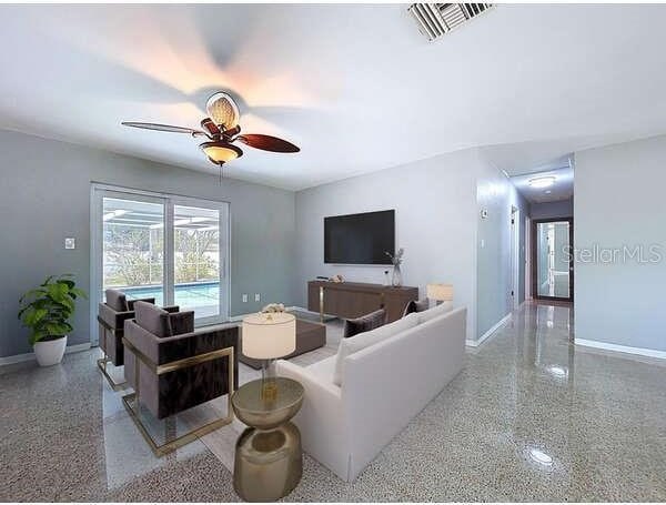 6268 39th Ave N, Saint Petersburg, FL 33709 - living room with baseboards, ceiling fan, speckled floor, and visible vents