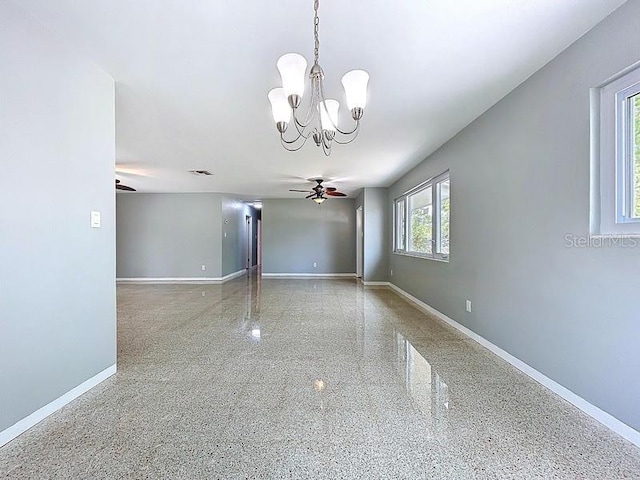 6268 39th Ave N, Saint Petersburg, FL 33709 - unfurnished room with baseboards, speckled floor, and ceiling fan with notable chandelier
