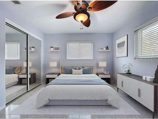 6268 39th Ave N, Saint Petersburg, FL 33709 - bedroom featuring a closet, ceiling fan, speckled floor, and visible vents