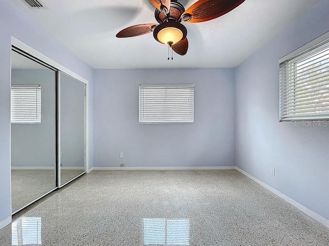 6268 39th Ave N, Saint Petersburg, FL 33709 - unfurnished bedroom with ceiling fan, speckled floor, baseboards, visible vents, and a closet