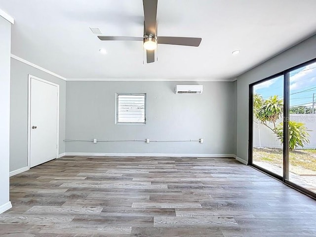6268 39th Ave N, Saint Petersburg, FL 33709 - empty room with ornamental molding, wood finished floors, baseboards, a wall mounted air conditioner, and a ceiling fan