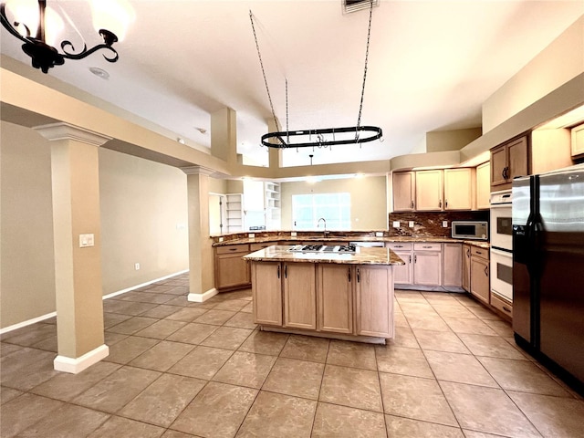 kitchen with a center island, backsplash, white appliances, and light tile patterned flooring