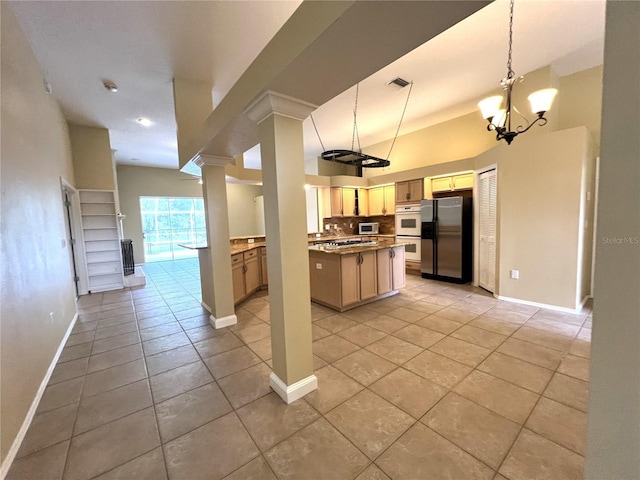kitchen featuring baseboards, light tile patterned flooring, visible vents, and stainless steel appliances