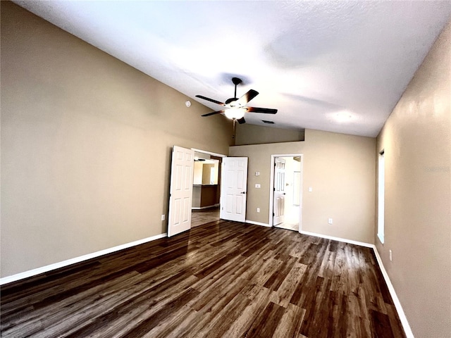 unfurnished bedroom with ceiling fan, vaulted ceiling, dark wood finished floors, baseboards, and a closet