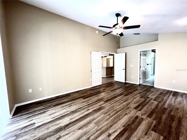 unfurnished bedroom featuring ensuite bath, high vaulted ceiling, baseboards, visible vents, and dark wood-style floors