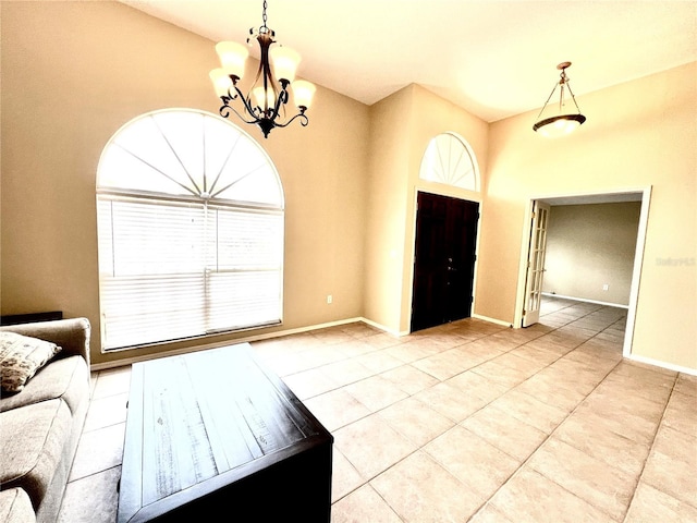 tiled entryway with an inviting chandelier, baseboards, and a wealth of natural light