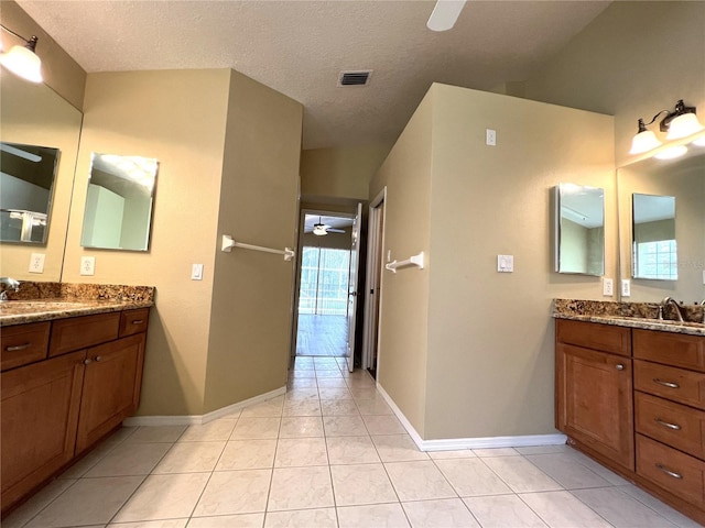 bathroom with a sink, baseboards, a ceiling fan, and visible vents