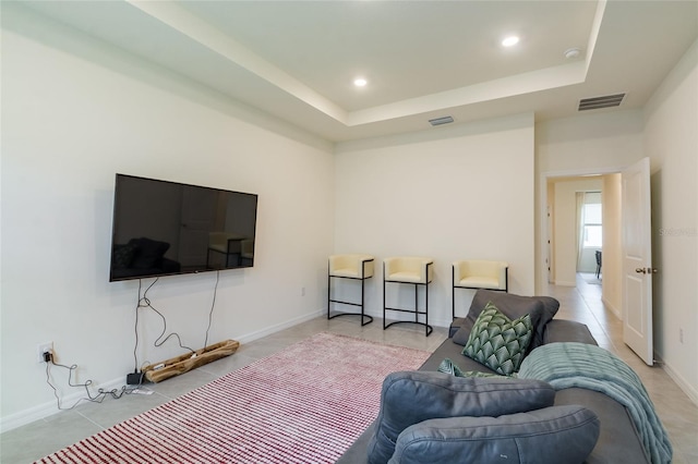 living area with visible vents, baseboards, recessed lighting, a raised ceiling, and light tile patterned floors