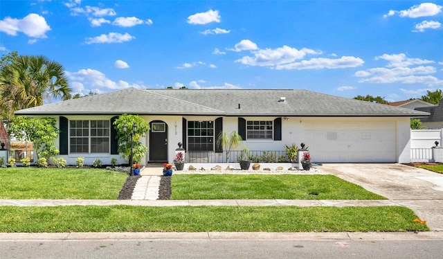 ranch-style home with an attached garage, stucco siding, a front lawn, roof with shingles, and driveway