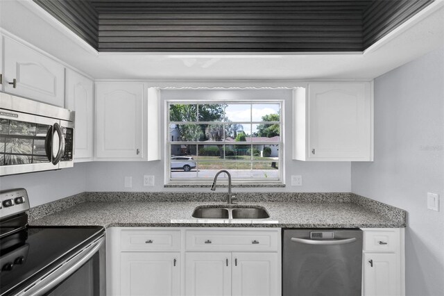 1913 Poinsetta Ln, Maitland, FL 32751 - kitchen featuring appliances with stainless steel finishes, a sink, and white cabinets