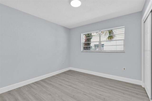 1913 Poinsetta Ln, Maitland, FL 32751 - unfurnished room featuring baseboards, wood finished floors, and a textured ceiling