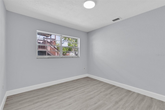 1913 Poinsetta Ln, Maitland, FL 32751 - unfurnished room featuring wood finished floors, baseboards, and a textured ceiling