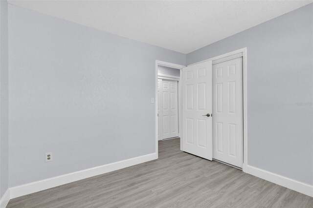 1913 Poinsetta Ln, Maitland, FL 32751 - unfurnished bedroom with baseboards, light wood finished floors, and a closet