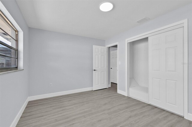 1913 Poinsetta Ln, Maitland, FL 32751 - unfurnished bedroom with baseboards, wood finished floors, and a closet