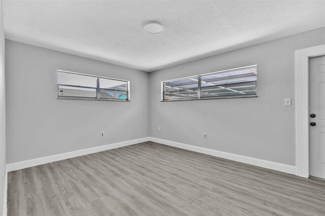 1913 Poinsetta Ln, Maitland, FL 32751 - unfurnished room featuring wood finished floors, baseboards, and a textured ceiling