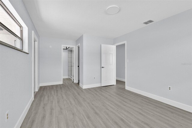 1913 Poinsetta Ln, Maitland, FL 32751 - unfurnished bedroom with light wood-style floors, baseboards, and a closet