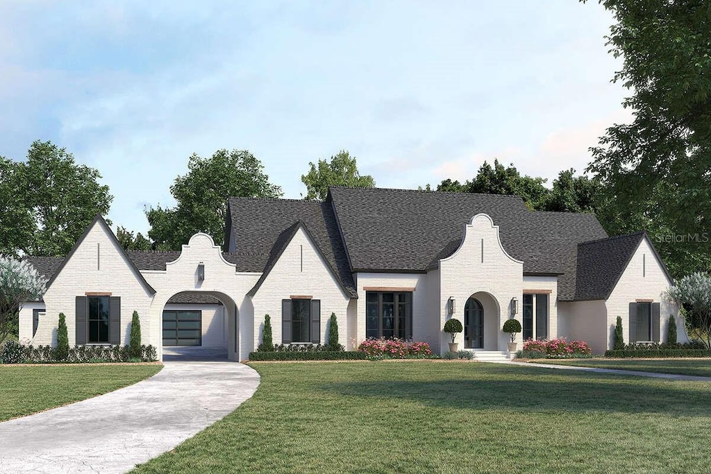 511 Avonwood, Tampa, FL 33625 - french provincial home featuring an attached garage, a front lawn, and driveway