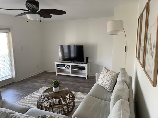 living room featuring baseboards, dark wood-style floors, and a ceiling fan