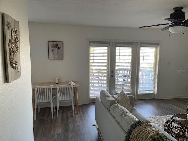 living room with ceiling fan, baseboards, plenty of natural light, and wood finished floors