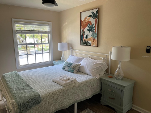 bedroom with dark wood-style flooring