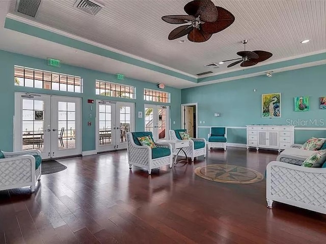 interior space with visible vents, wood finished floors, a raised ceiling, french doors, and a ceiling fan