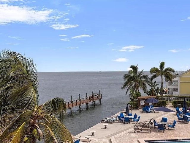 dock area with a water view and a patio area