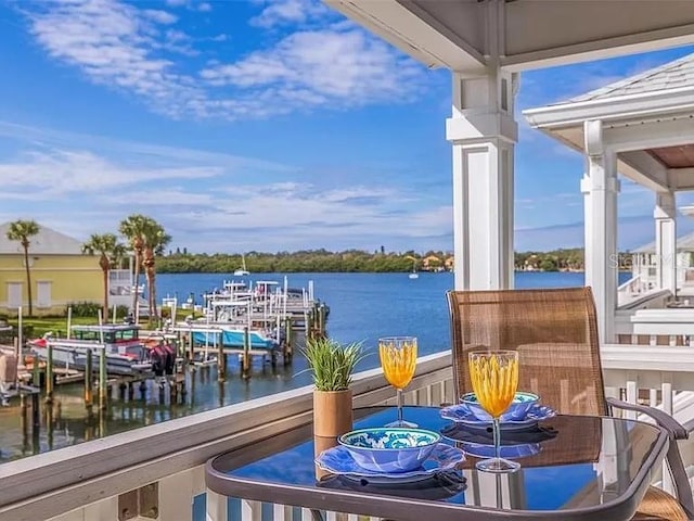 balcony with a boat dock and a water view
