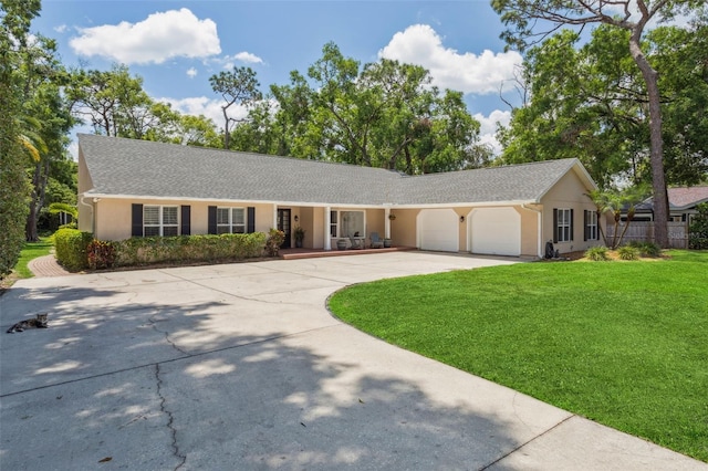 3906 Floyd Rd, Tampa, FL 33618 - single story home featuring a garage, concrete driveway, a front lawn, and stucco siding