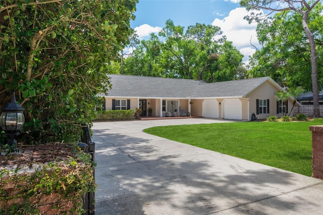 3906 Floyd Rd, Tampa, FL 33618 - ranch-style house with an attached garage, driveway, a front yard, stucco siding, and a shingled roof