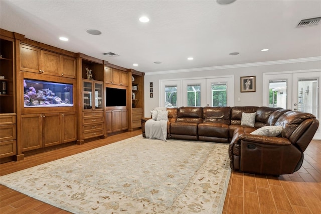 3906 Floyd Rd, Tampa, FL 33618 - living room featuring ornamental molding, light wood-type flooring, and recessed lighting