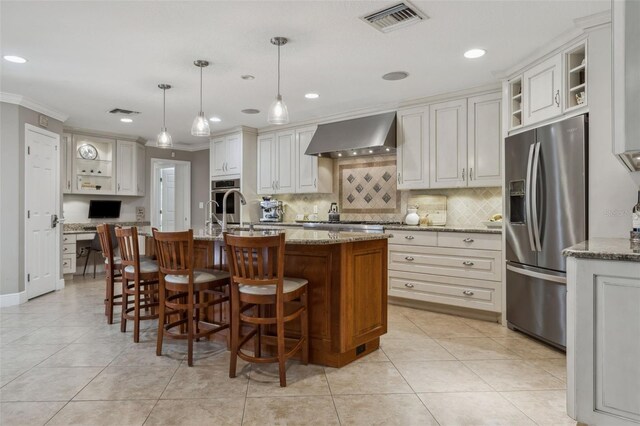 3906 Floyd Rd, Tampa, FL 33618 - kitchen with appliances with stainless steel finishes, wall chimney exhaust hood, crown molding, tasteful backsplash, and an island with sink