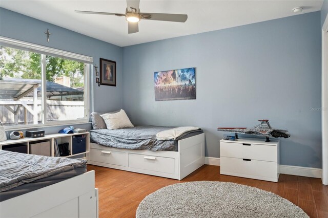 3906 Floyd Rd, Tampa, FL 33618 - bedroom featuring wood finished floors, baseboards, and ceiling fan