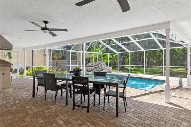 3906 Floyd Rd, Tampa, FL 33618 - swimming pool featuring ceiling fan, a patio, outdoor dining area, and glass enclosure