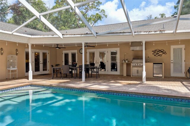 3906 Floyd Rd, Tampa, FL 33618 - swimming pool featuring french doors, a ceiling fan, a patio area, and a lanai