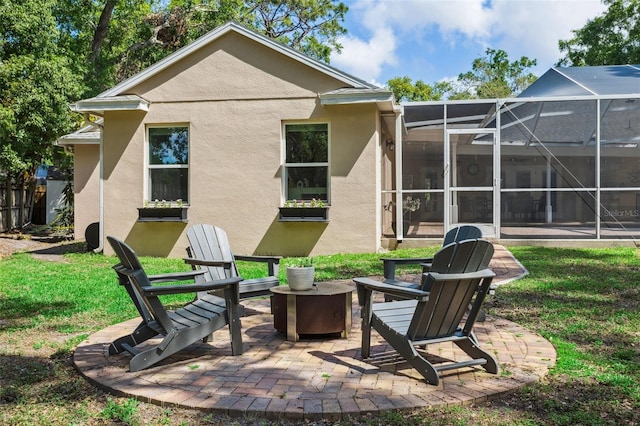 3906 Floyd Rd, Tampa, FL 33618 - back of property with stucco siding, an outdoor fire pit, a patio area, a lanai, and a lawn