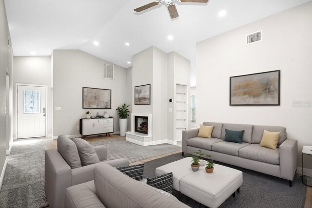 13613 Laraway Dr, Riverview, FL 33579 - living area featuring high vaulted ceiling, a fireplace with raised hearth, baseboards, a ceiling fan, and recessed lighting