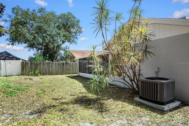13613 Laraway Dr, Riverview, FL 33579 - fenced backyard with cooling unit and a sunroom