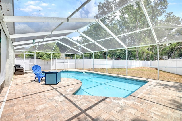 view of swimming pool with a patio, a fenced in pool, a lanai, and a fenced backyard