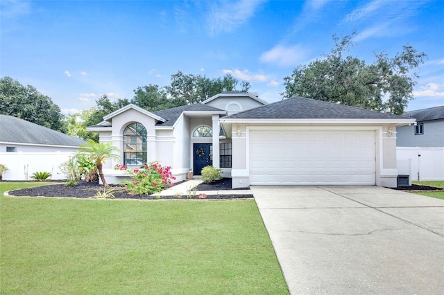 ranch-style home with fence, a front lawn, a garage, stucco siding, and concrete driveway