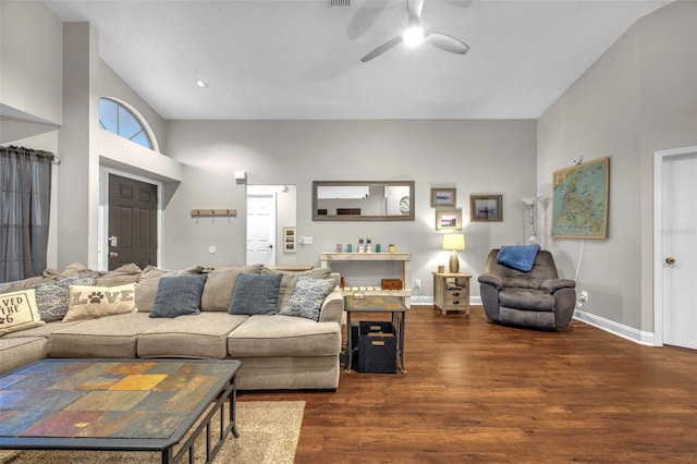 living area featuring baseboards, ceiling fan, and wood finished floors
