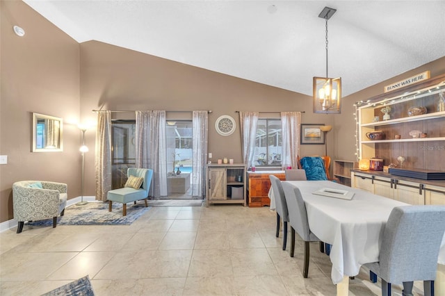 dining area featuring baseboards, high vaulted ceiling, light tile patterned flooring, and a notable chandelier