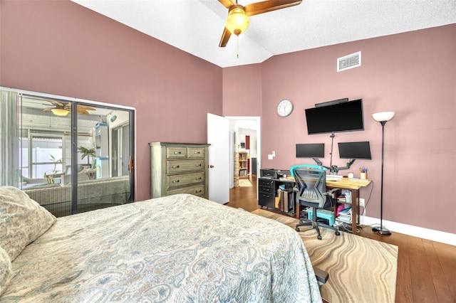 bedroom featuring access to exterior, baseboards, wood finished floors, vaulted ceiling, and visible vents