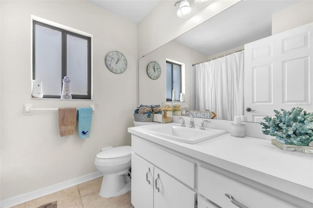 bathroom featuring toilet, baseboards, tile patterned floors, and vanity