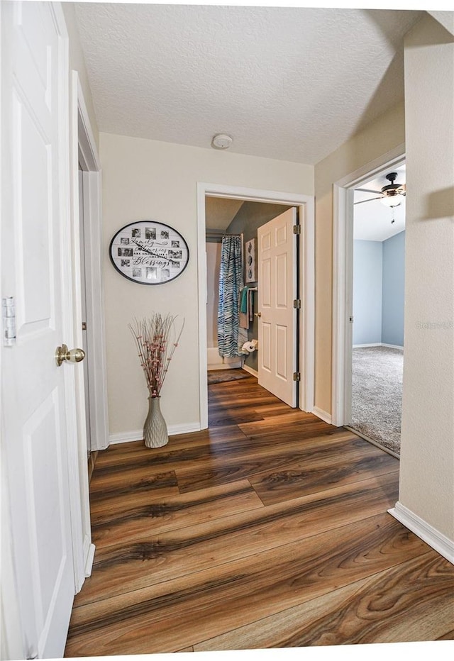 2604 Clareside Dr, Valrico, FL 33596 - hallway featuring baseboards, dark wood-style floors, and a textured ceiling