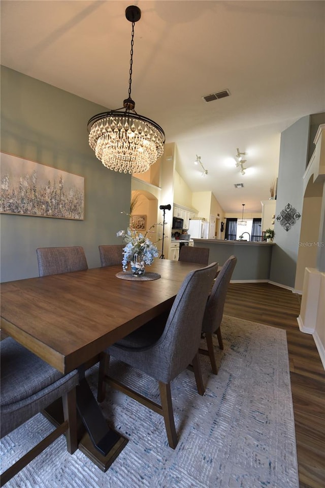 2604 Clareside Dr, Valrico, FL 33596 - dining space with wood finished floors, a chandelier, and baseboards