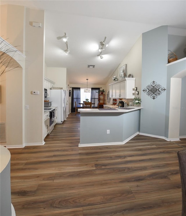 2604 Clareside Dr, Valrico, FL 33596 - kitchen featuring white cabinetry, a peninsula, dark wood-style floors, and decorative light fixtures